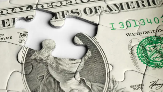 Financial Concept - Dollar bill puzzle with missing piece.