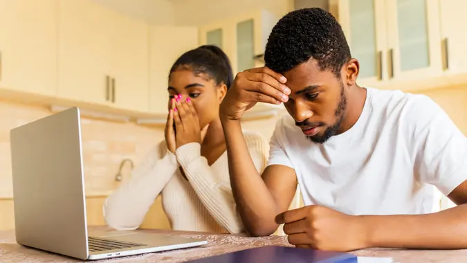 Stressed african american couple looking frustrated after getting a bad news from family.
