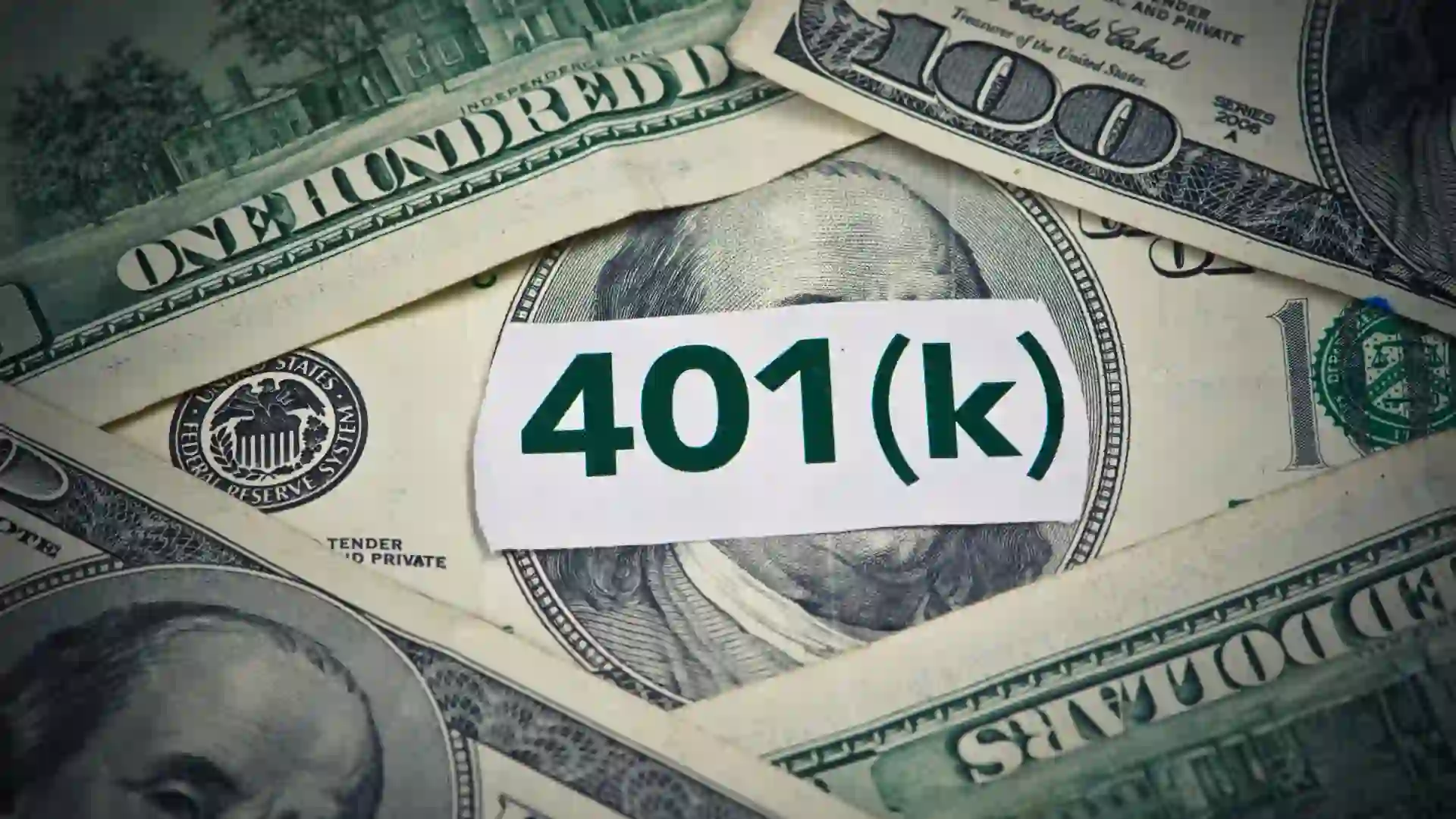 401(k) in bold green text, centered on a white backdrop with neatly stacked hundred-dollar bills underneath.