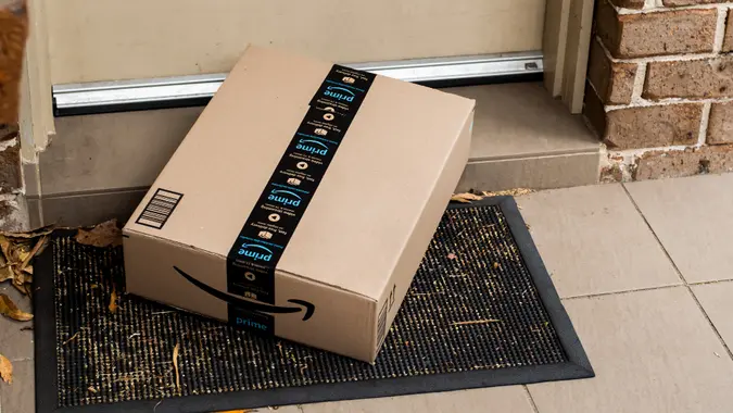 Amazon prime box delivered to a front door of residential building stock photo