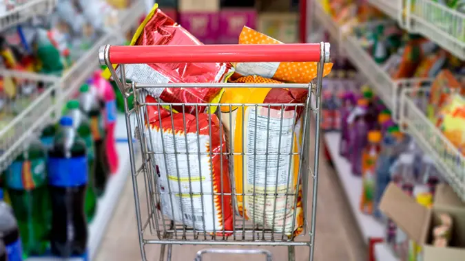Snack packs in shopping cart at store stock photo