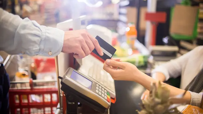 Man Paying with Credit Card in Supermarket stock photo