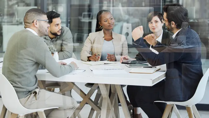 Shot of a group of businesspeople having a meeting in an office at work stock photo