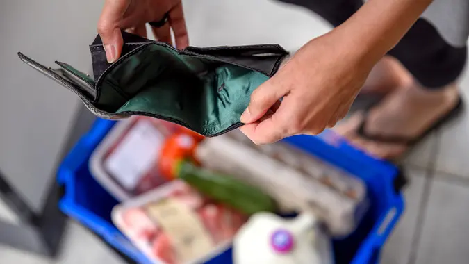 A woman ended up with an empty wallet after a buying essential food in a grocery store stock photo