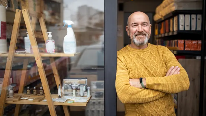 Portrait of proud Caucasian man, a home goods store owner in front of the store.