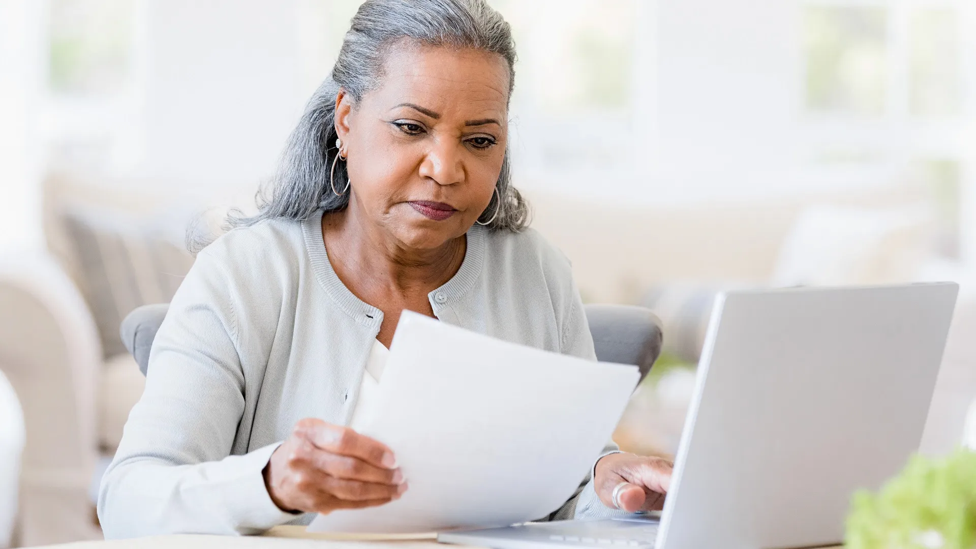 Serious senior widow worried about home finances stock photo