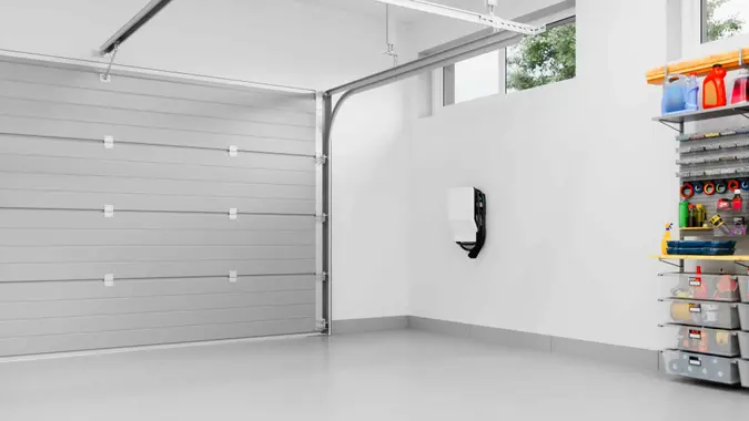 Interior of an empty modern residential garage with EV charger.