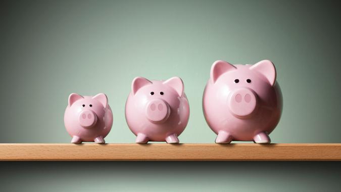 Three piggy banks on the shelf.