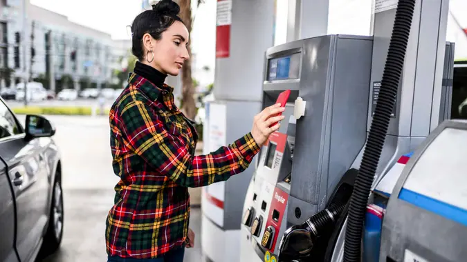 Contactless payment at a gas station. Woman getting gas.