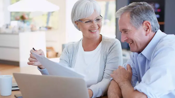 Shot of a senior couple working on their finances using a laptop