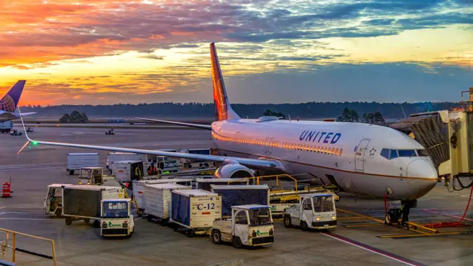 Houston, United States - December 22, 2021: A United Airlines flight at the gate awaiting boarding at sunrise at Houston's George Bush Intercontinental Airport.