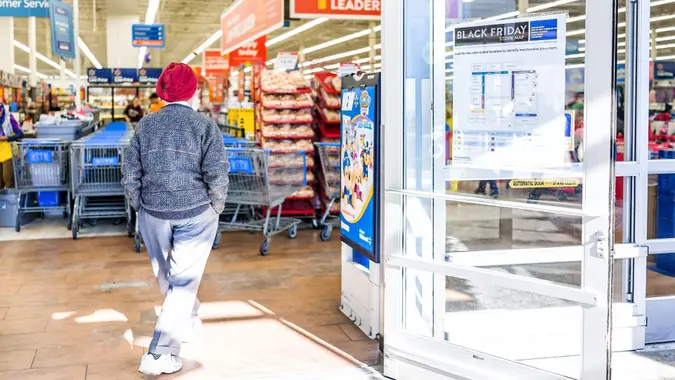 Burke, USA - November 24, 2017: Black Friday sign in Walmart store entrance with map after Thanksgiving shopping consumerism in Virginia with sikh man walking inside.