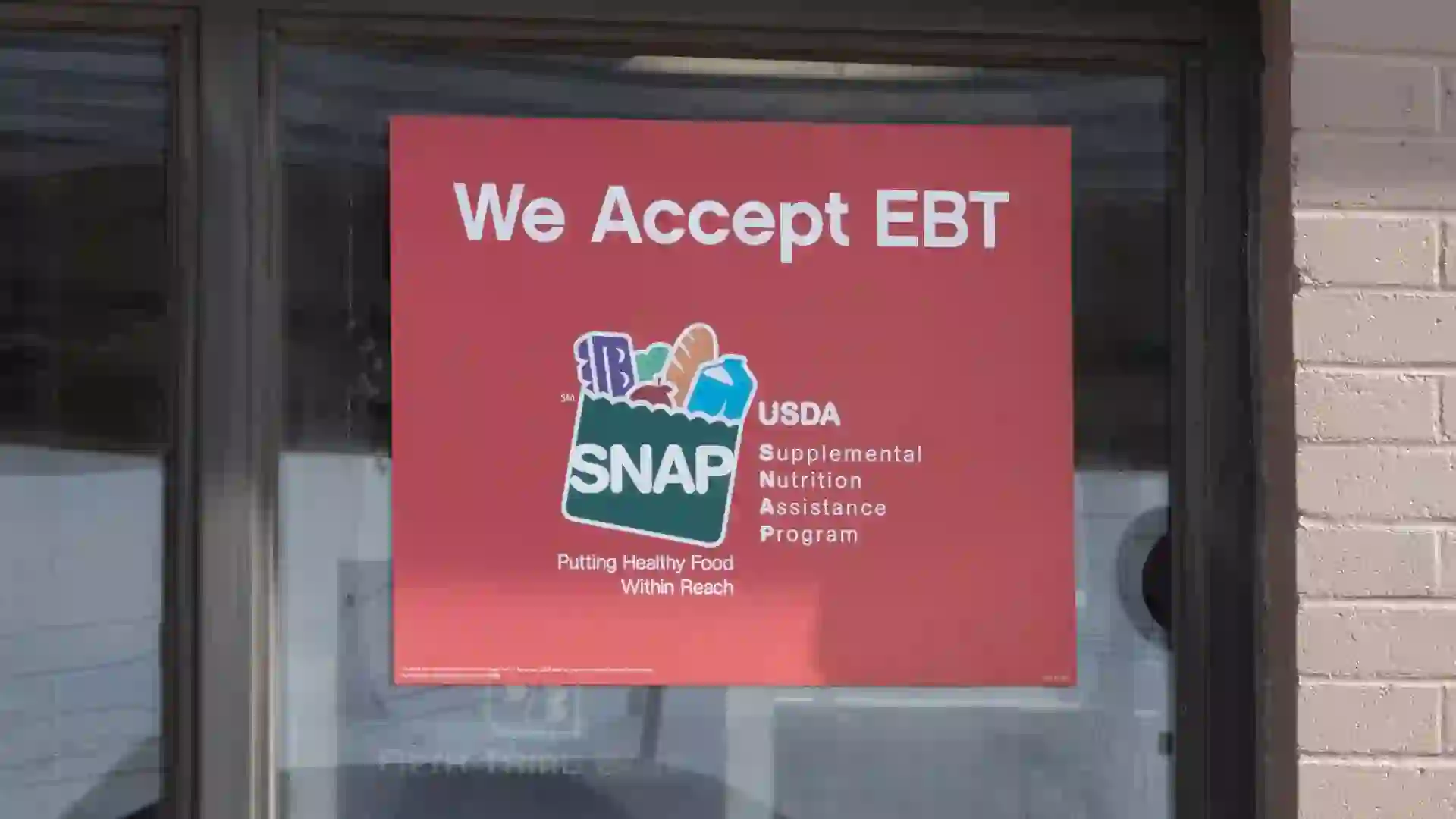 SNAP and EBT Accepted here sign. SNAP and Food Stamps provide nutrition benefits to supplement the budgets of disadvantaged families. stock photo
