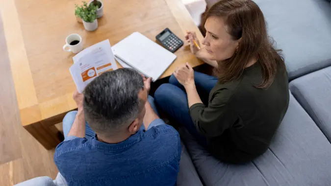 Couple at home talking about their home finances stock photo