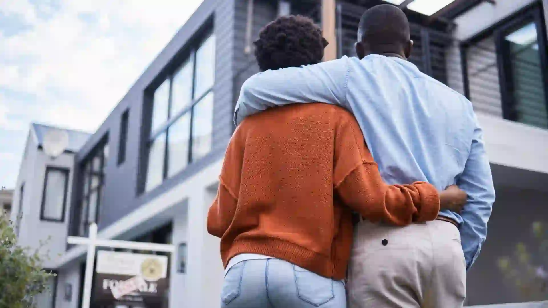 Homeowners in the neighbourhood of their dreams after purchasing a home or new property for real estate investing.