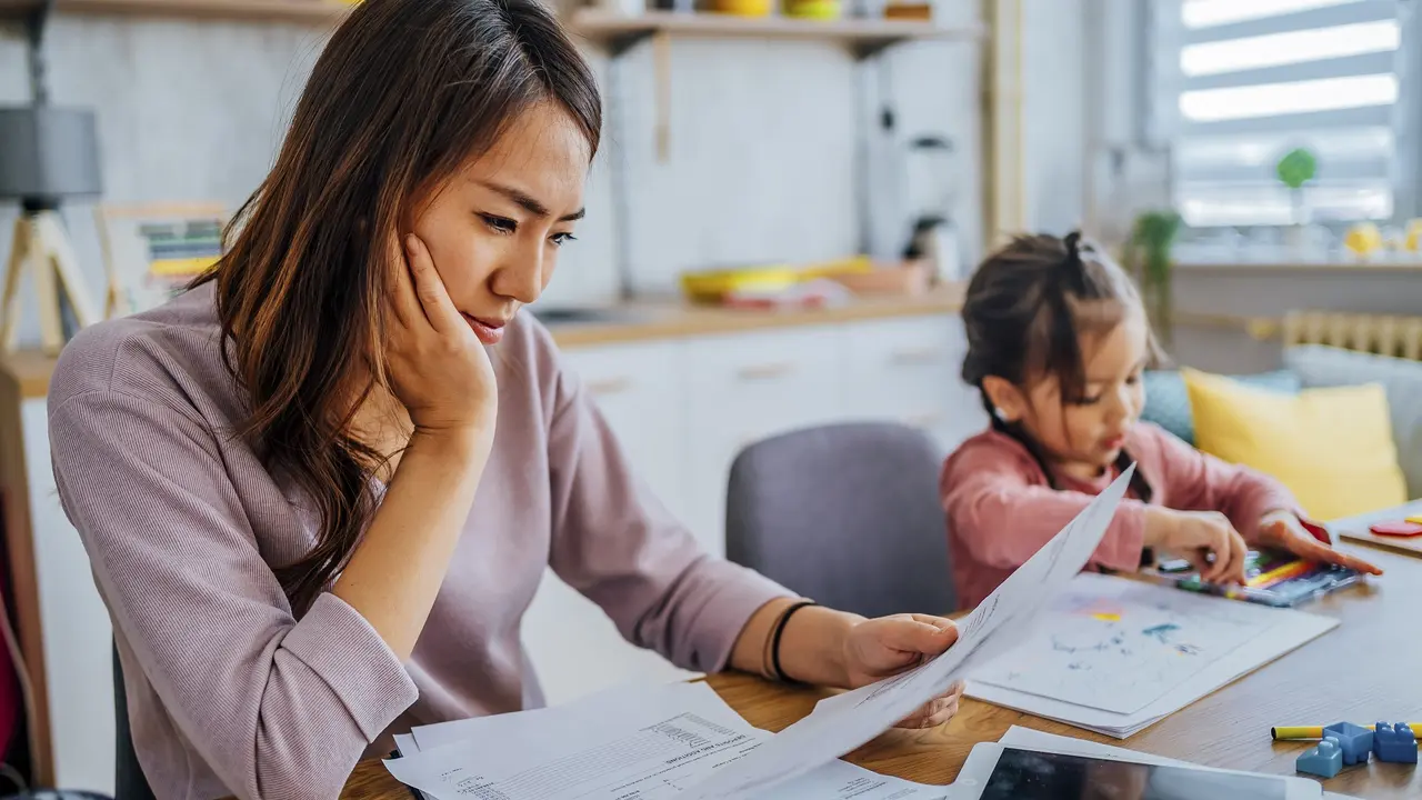 Stressed mother going through her finances stock photo