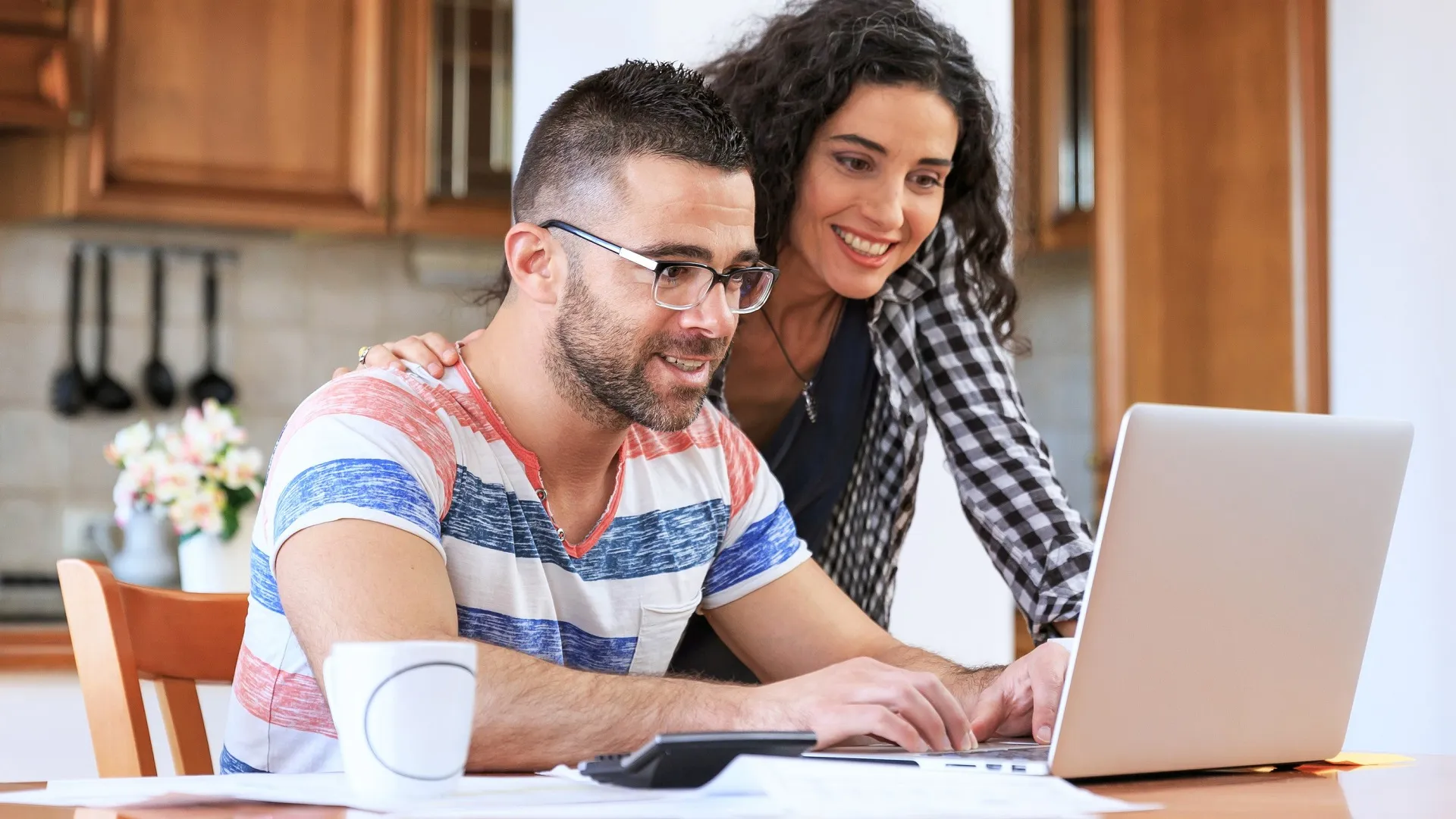 Couple using laptop at home stock photo