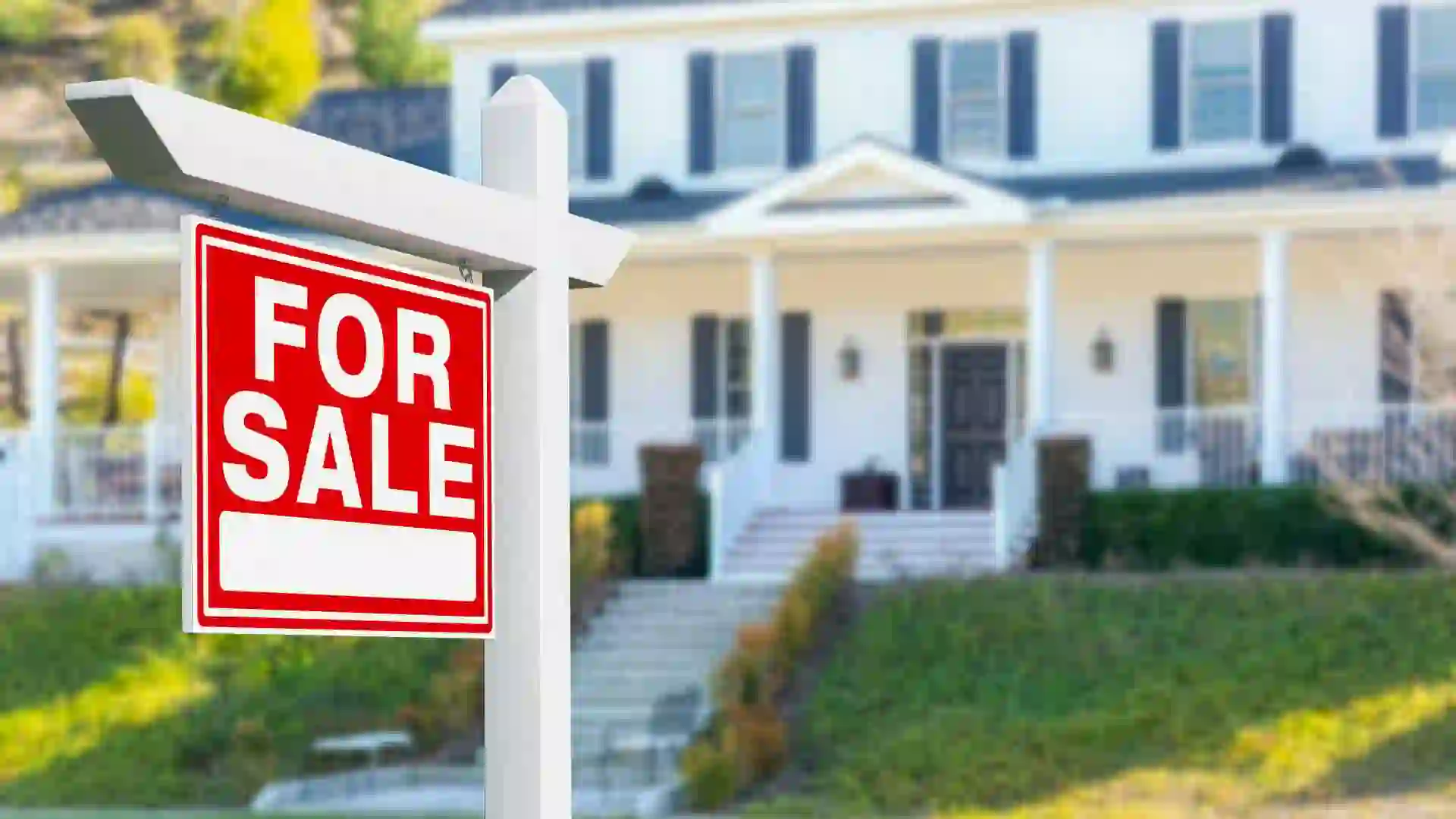 For Sale Real Estate Sign in Front of New House.