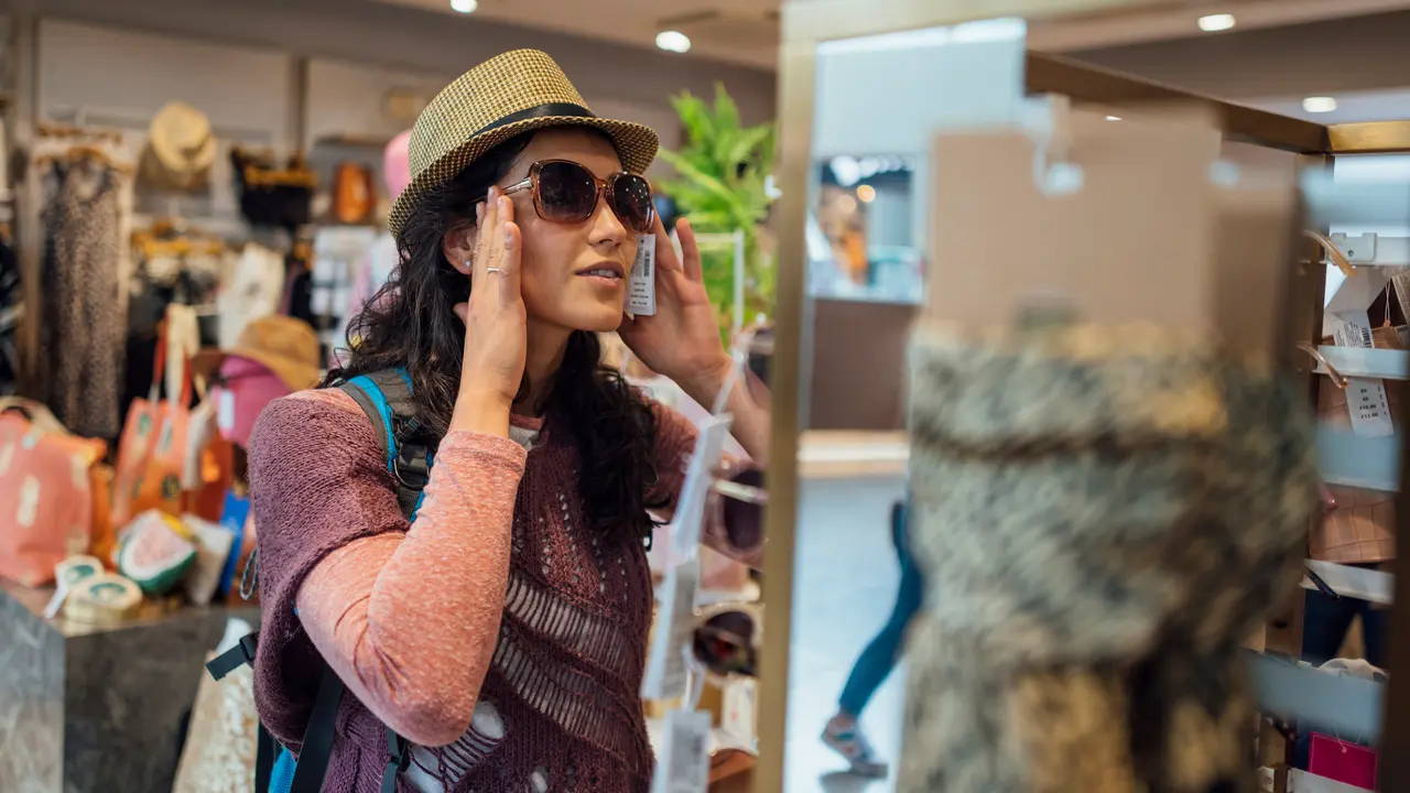 A young woman in an accessory shop in an airport in Toulouse, France.