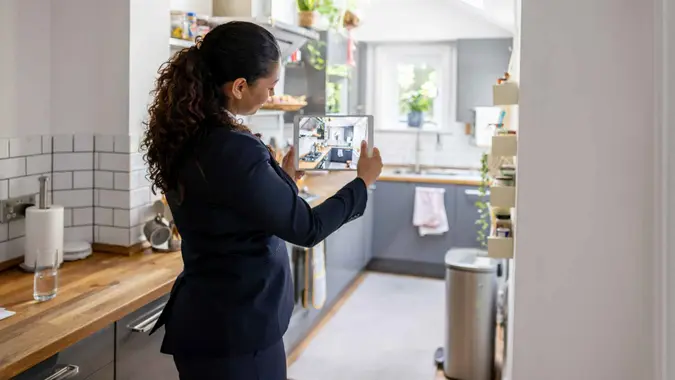 Real estate agent doing a virtual showing online using a tablet computer and live streaming.