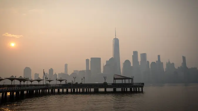 Mandatory Credit: Photo by Vanessa Carvalho/Shutterstock (13955299g)The sun rises behind the One World Trade Center, while the smoke from Canada wildfires covers the Manhattan borough as it is seen from Liberty State Park on June 8, 2023 in New Jersey.