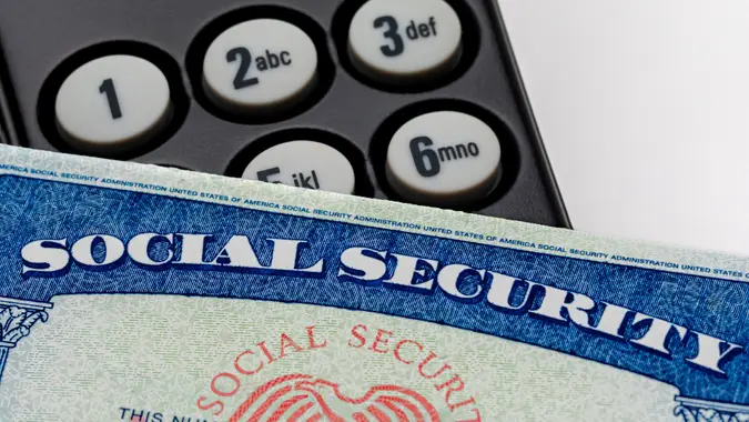 Social security card and telephone. Fraud, scam and identity theft concept. stock photo