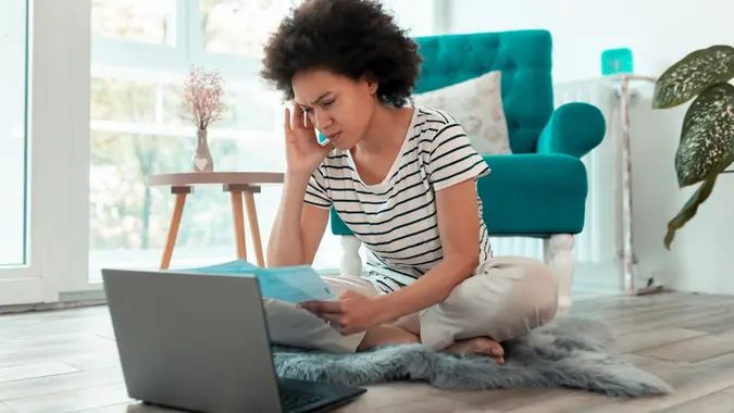 Woman paying bills online stock photo