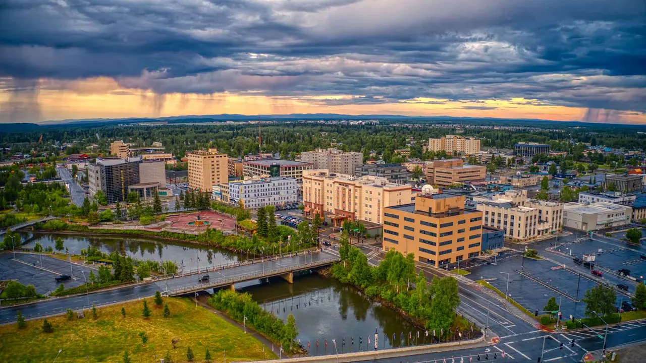 Aerial picture of Downtown Fairbanks, Alaska with tall buildings during a stormy Summer Sunset.