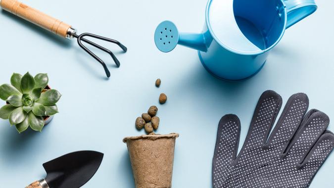 Gardening tools on blue background. Spring garden works concept. World environment day, arbor day, International mother day. Top view Gardening tools on blue background.