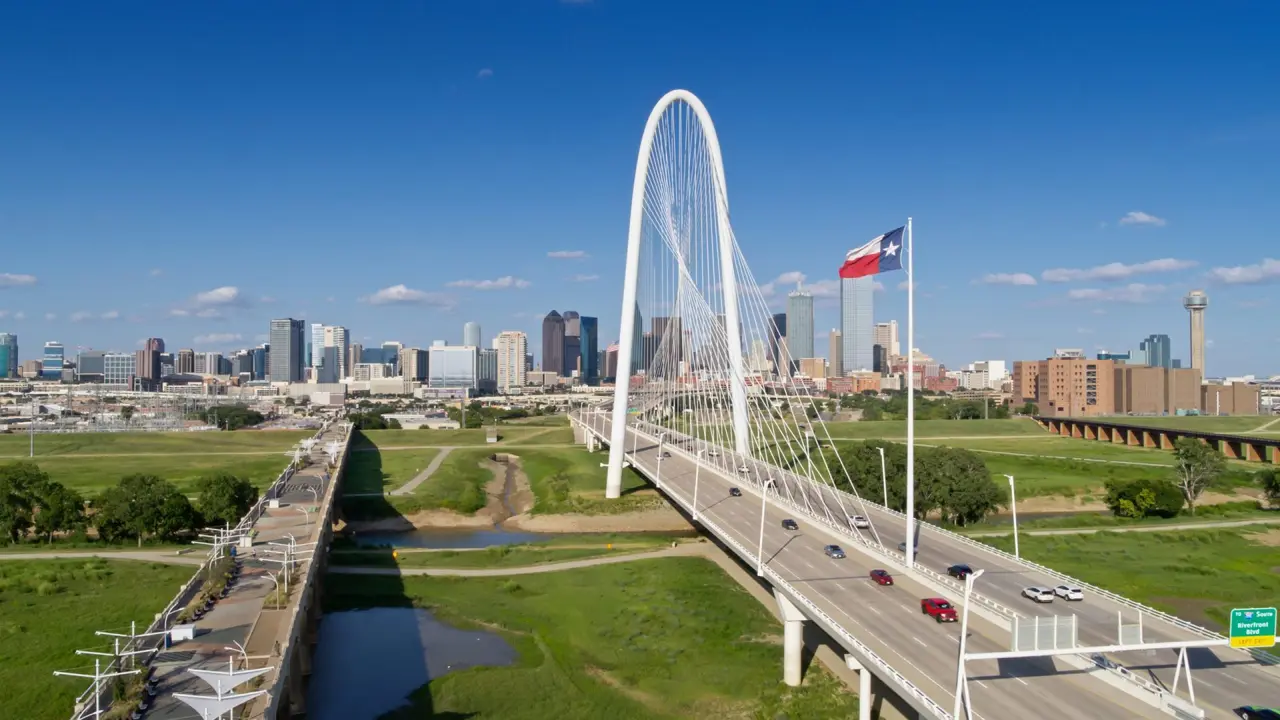 Aerial view of Dallas, Texas, looking along the Margaret Hunt Hill and Roland Kirk bridges across the Trinity River into downtown Dallas on a sunny summer day.