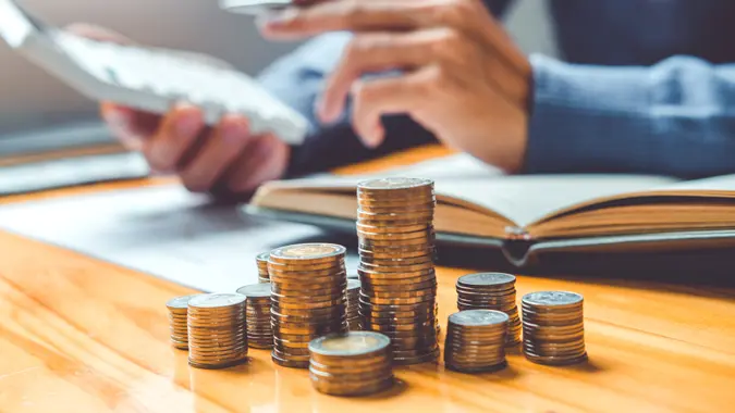 Saving money concept Man hand putting Row and coin Write Finance Saving money concept Man hand putting Row and coin Write Finance.