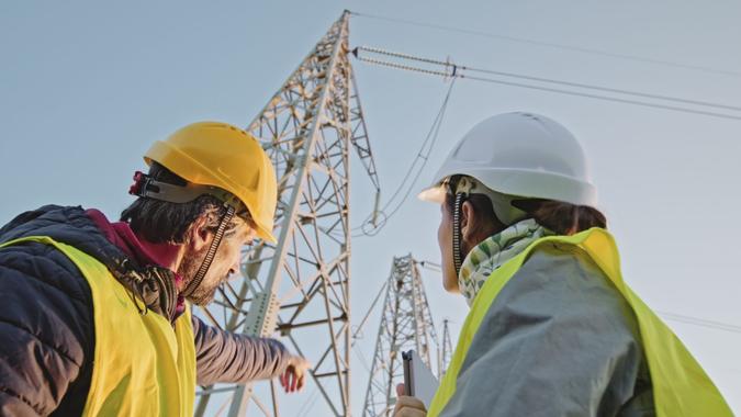 Electrical engineers working on Electrical Pylons Translation, discussing the condition of the Electrical Power Pole.