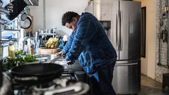 Sad mid adult man in the kitchen at home stock photo