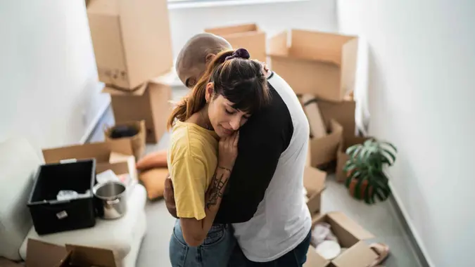Couple embracing leaving home.