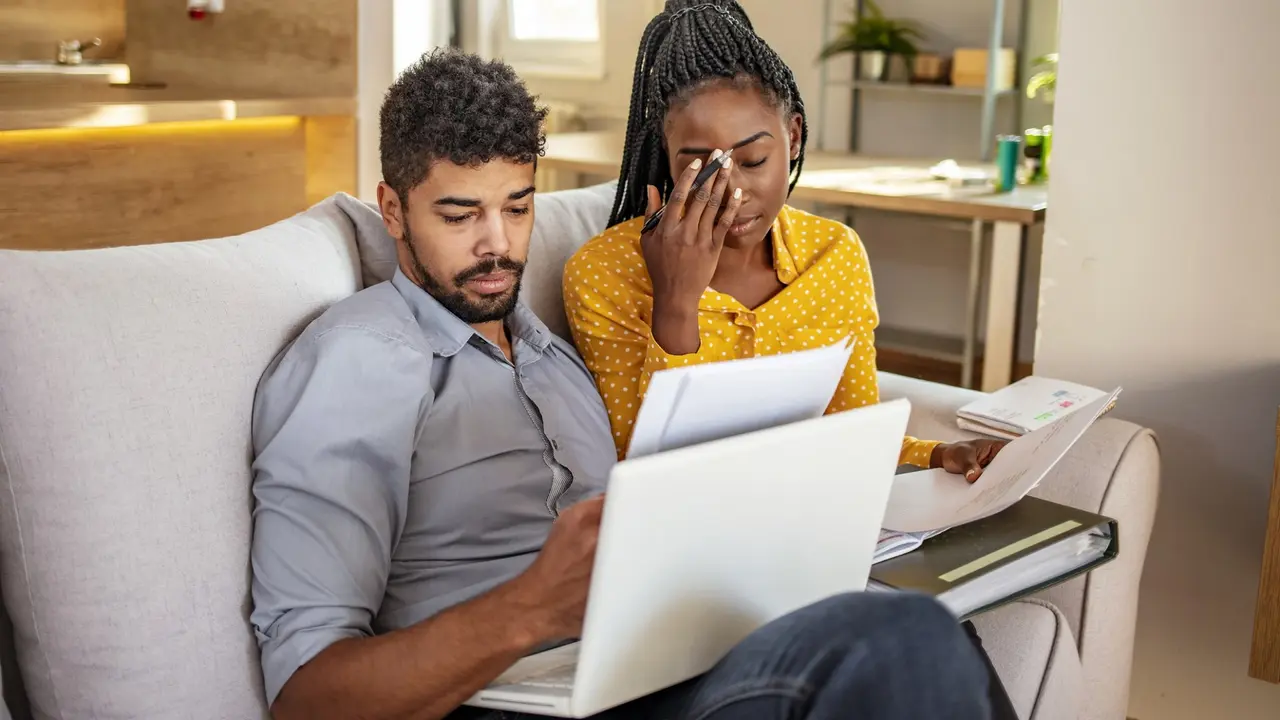 Stressed couple looking over papers