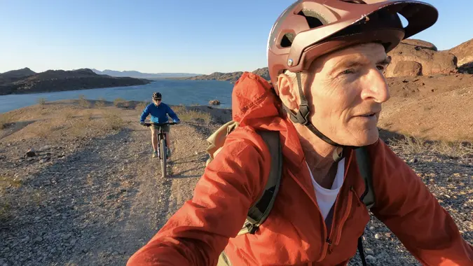 First person perspective of senior couple mountain biking stock photo
