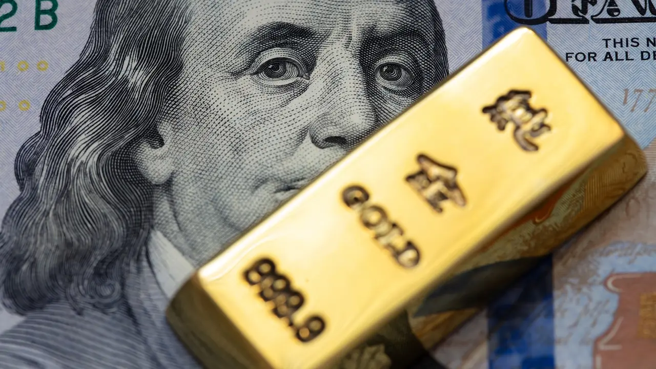 Stock photo of gold bars on a background of US 100 dollar bills