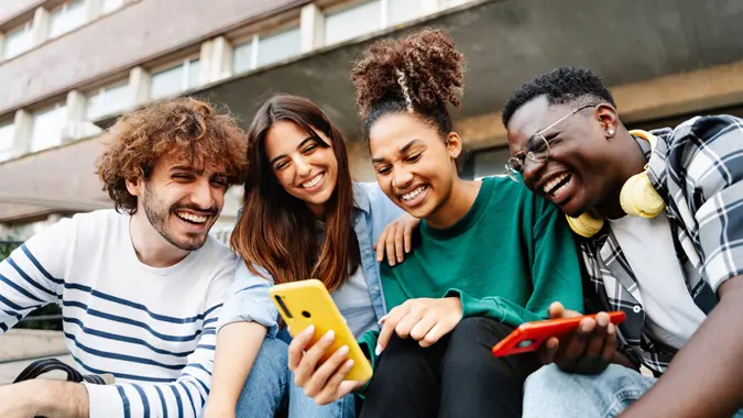 Group of Generation young people looking at their phone