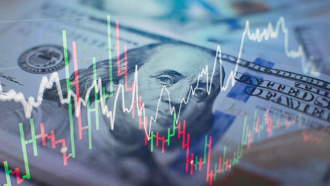 Stock chart lines in front of a $100 dollar bill