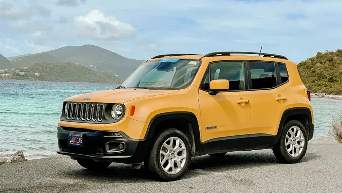 Yellow Jeep car in front of a nature background