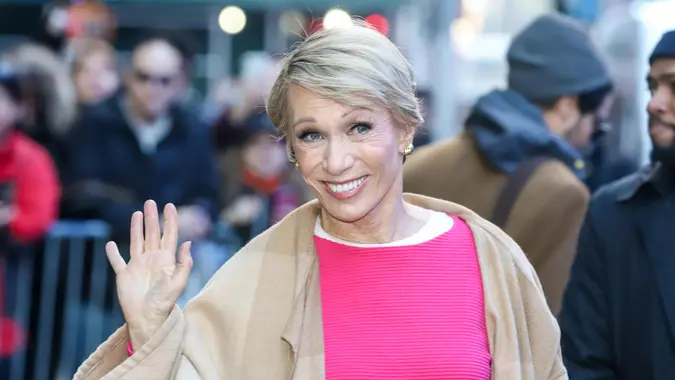 Barbara Corcoran wears a pink shirt and smiles outside the GMA TV studios