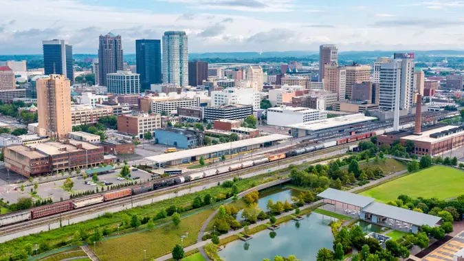 Aerial drone view of Birmingham, Alabama skyline with park and train station in the foreground.