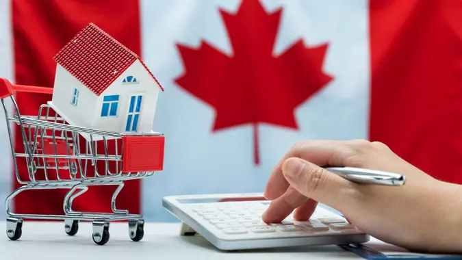 Using calculator to calculate home loan mortgage.