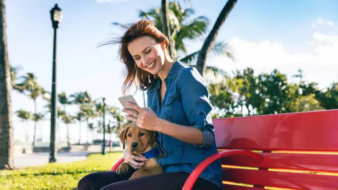 Woman with his Labrador puppy during a beautiful day at the park in Miami Beach.
