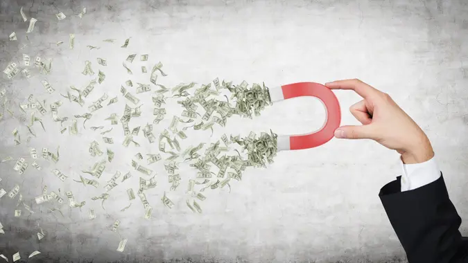 Hand attracts money stock photo