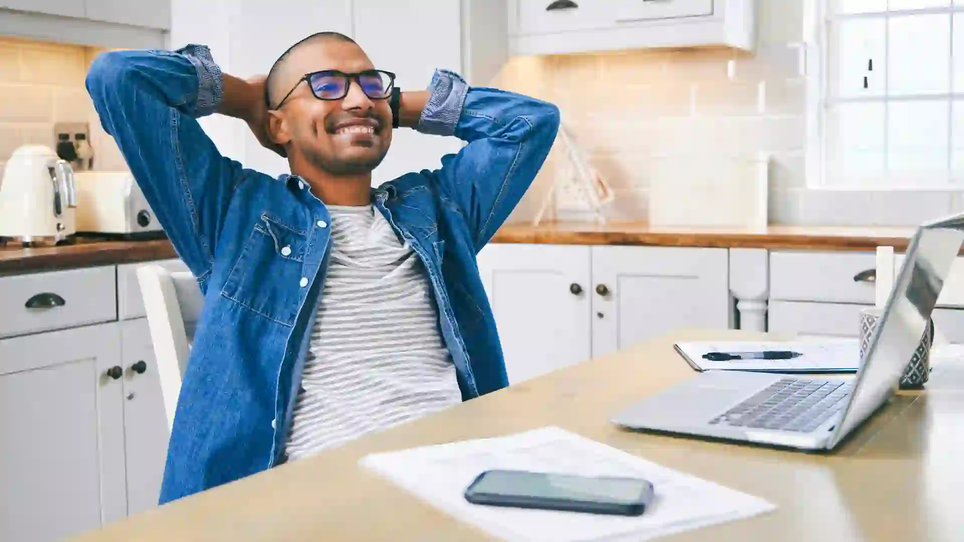 Man relaxing with his hands behind his head