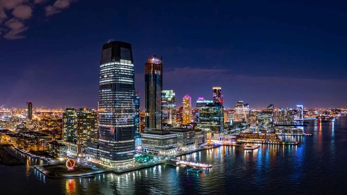 Aerial panorama of Jersey City skyline at night.