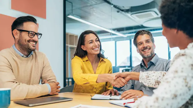 Cropped shot of two businesspeople shaking hands during a meeting at the office.