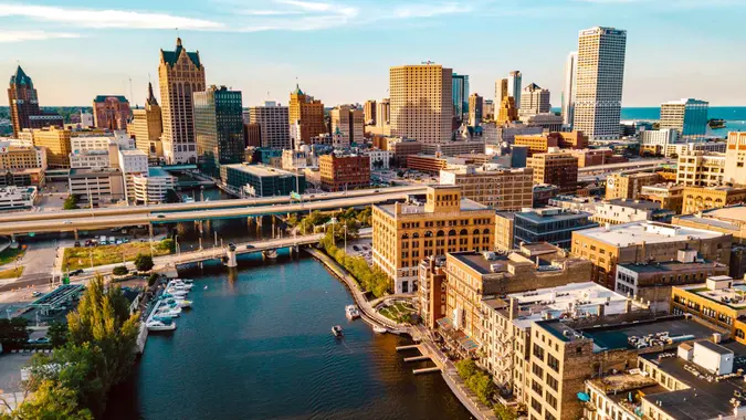 The Milwaukee skyline sits behind the view of the Milwaukee River.