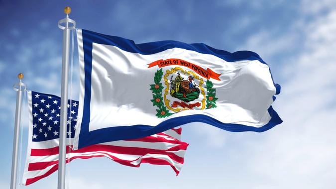 The West Virginia state flag waving along with the national flag of the United States of America.